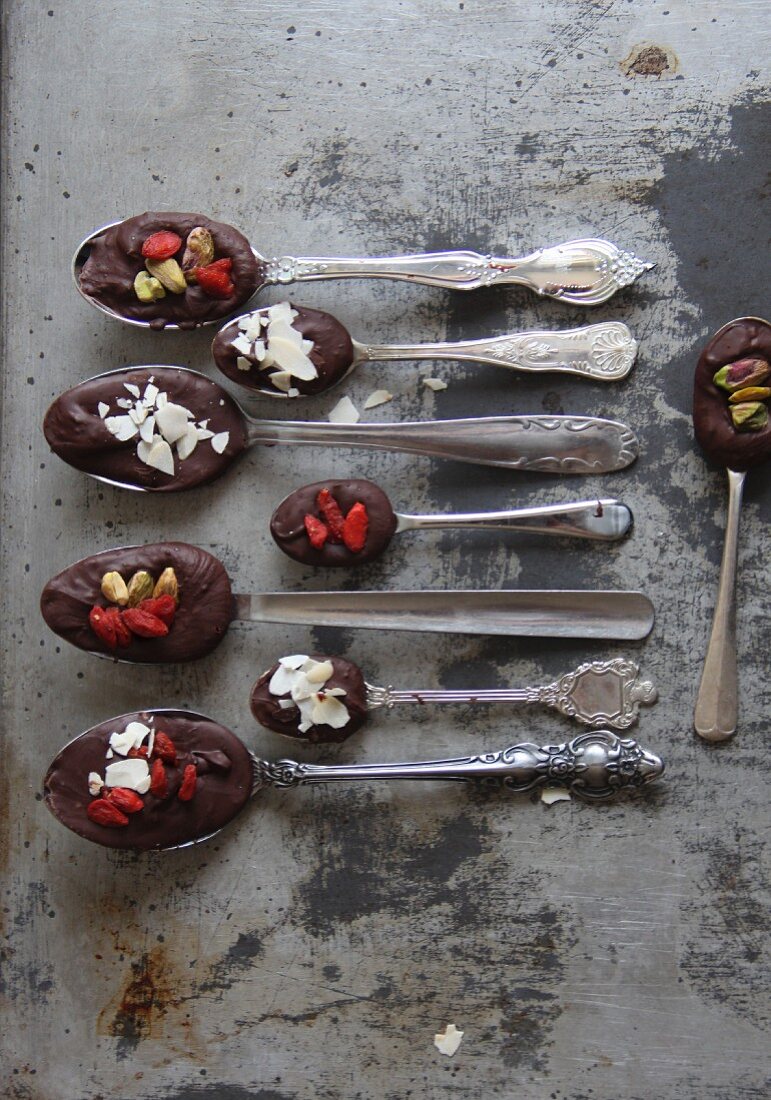 Spoons of chocolate, goaded berries and nuts