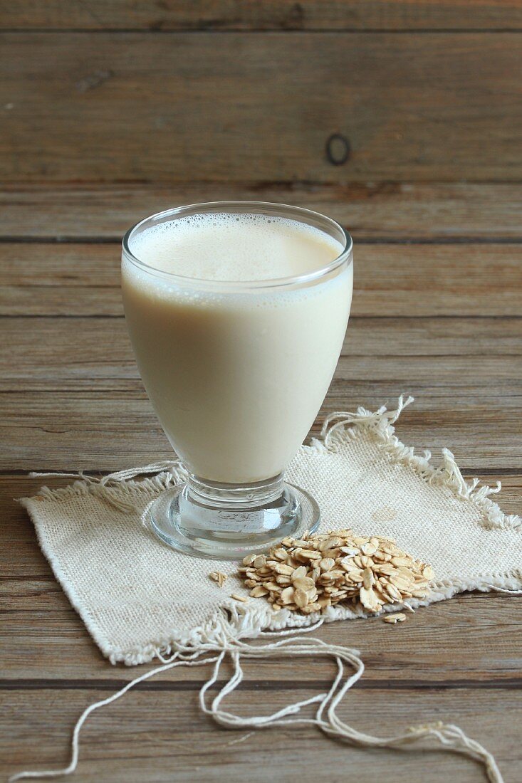 A glass of oat milk with oats