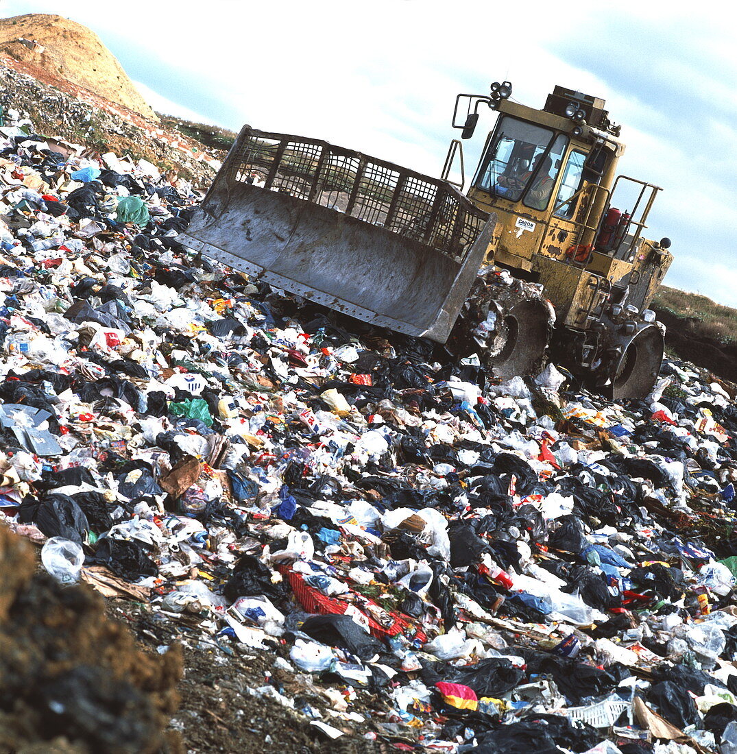 View of a bulldozer working a landfill refuse site