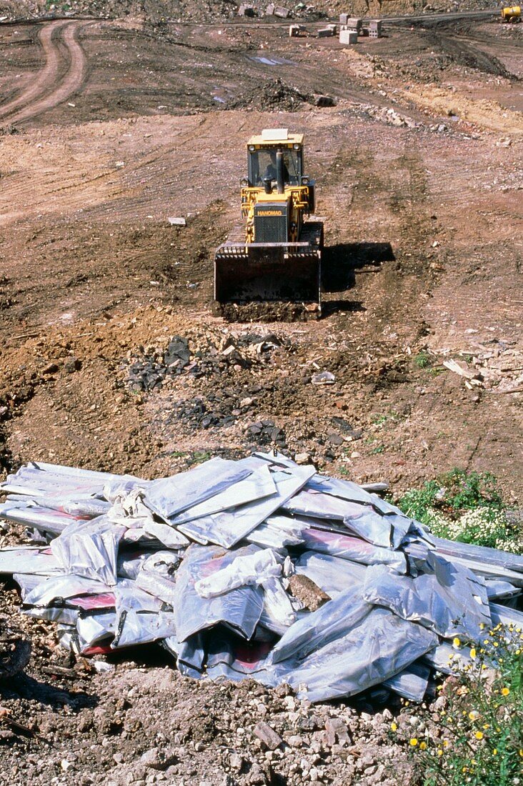 Sacks of asbestos being buried at landfill site