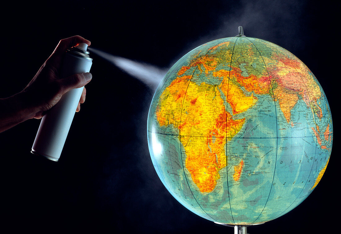 Aerosol spraying onto a globe of Earth