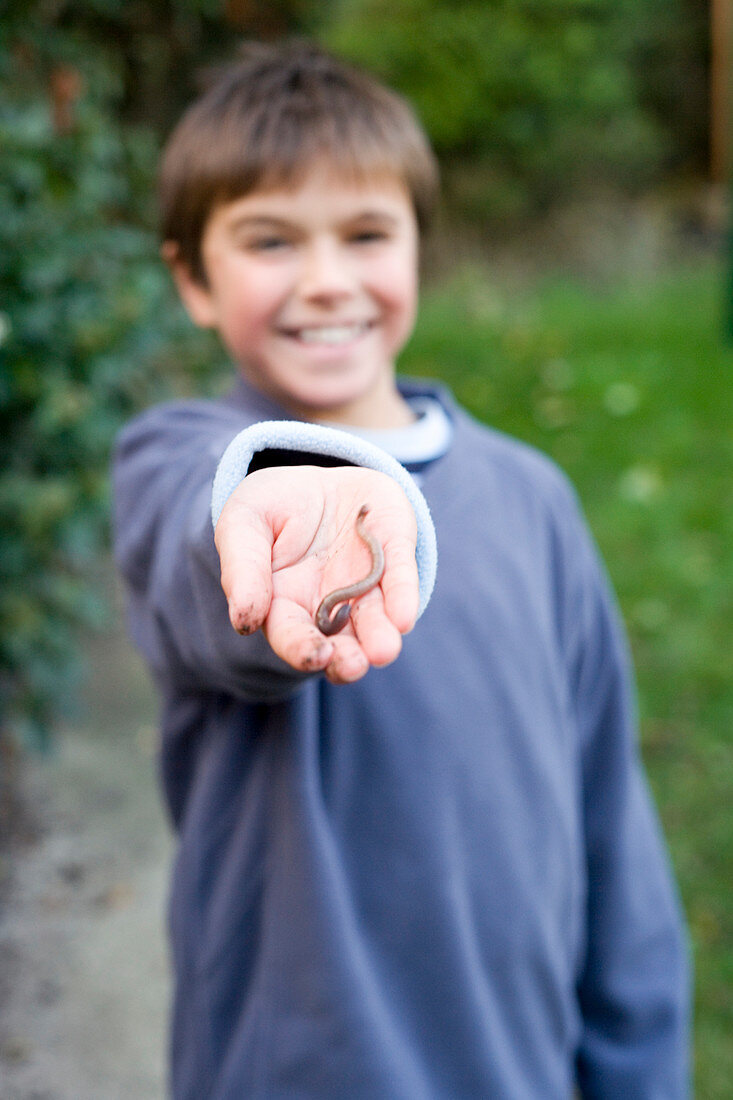 Boy holding an earthworm