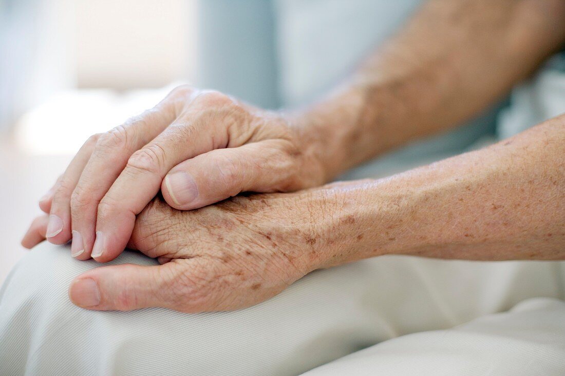 Senior couple holding hands