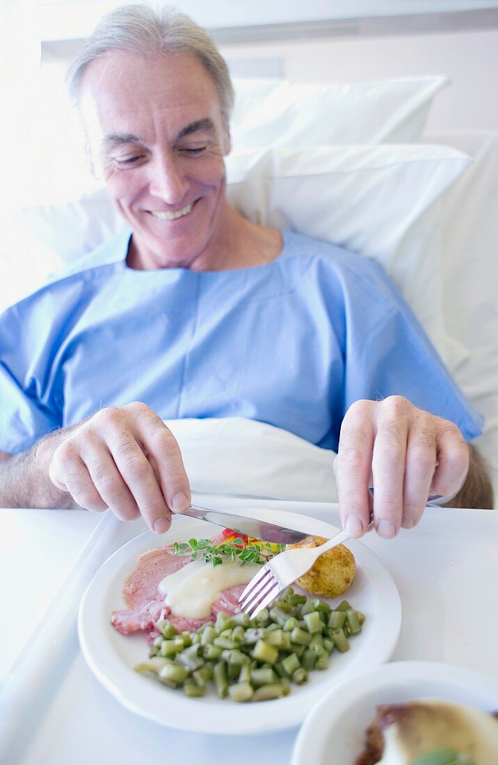 Senior patient eating a hospital meal