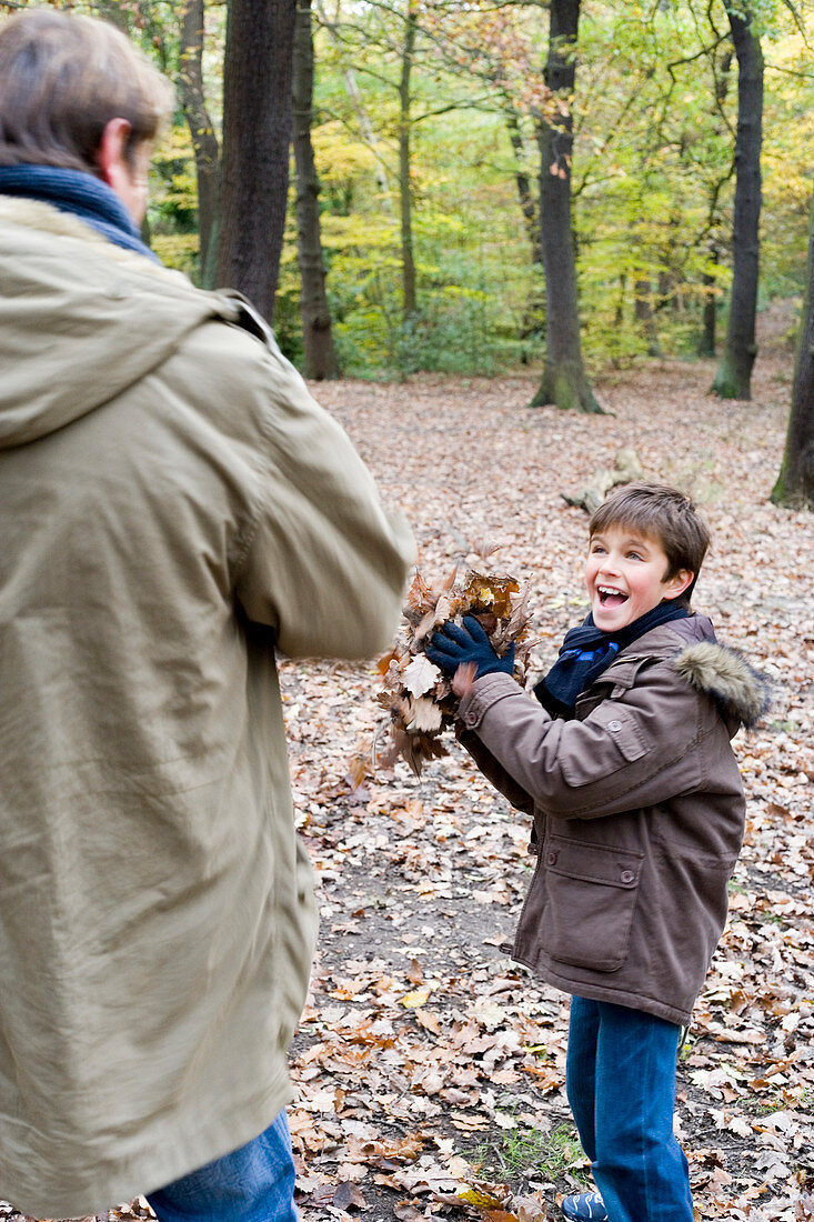Father and son playing in a wood