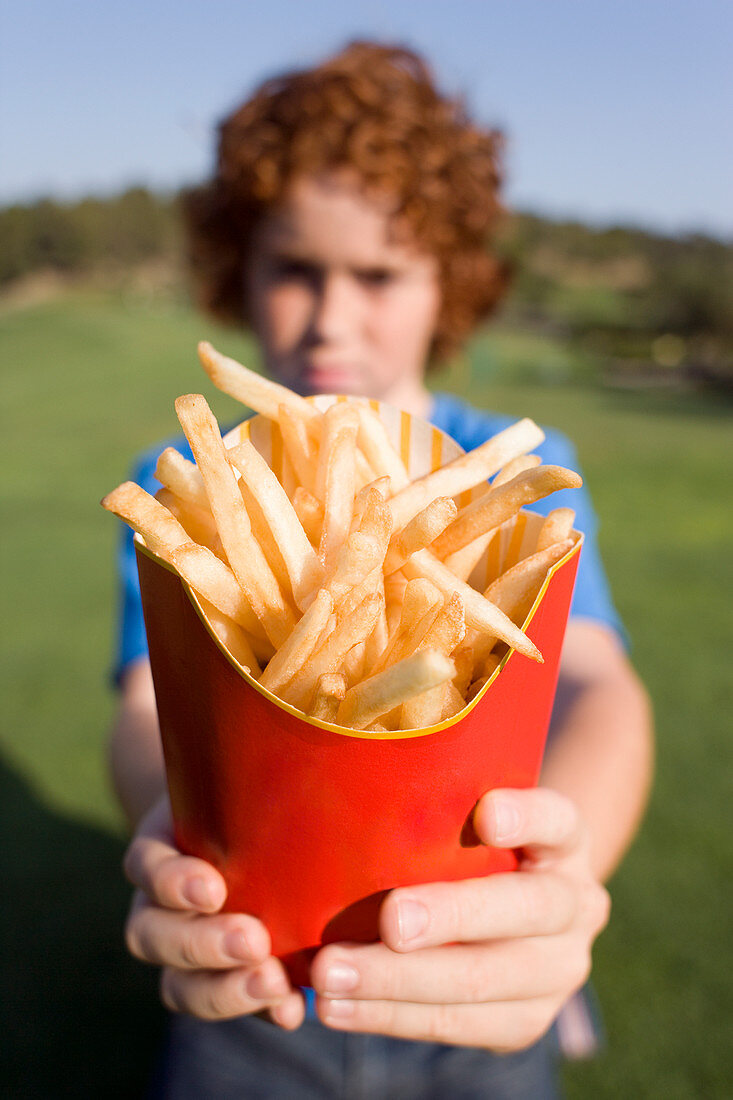 Boy holding chips