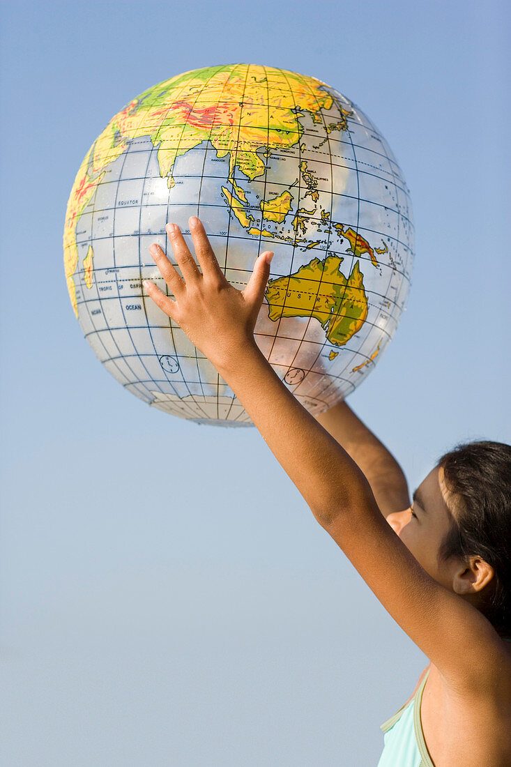 Girl holding an inflated globe