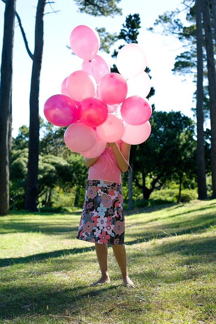 Woman holding balloons