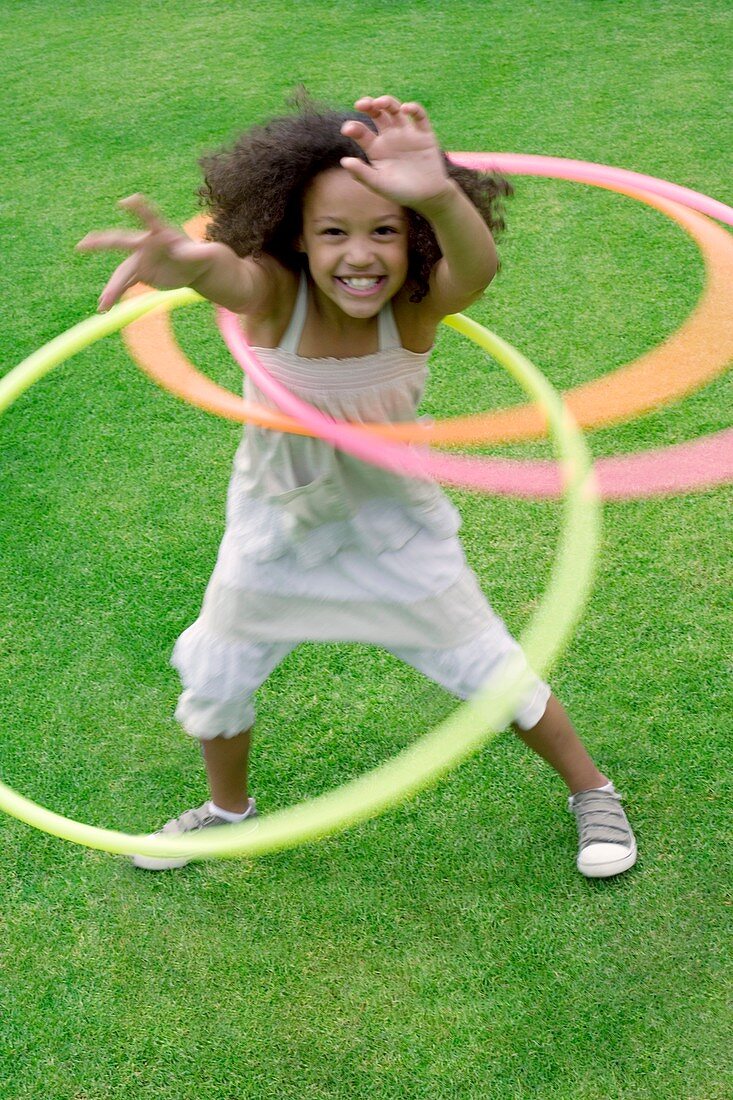 Girl playing with hula hoops