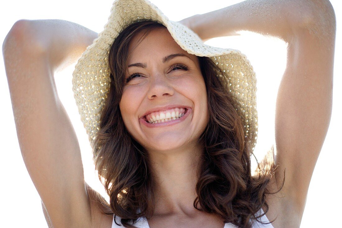 Happy woman wearing a sunhat