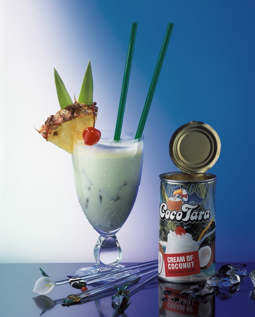 A pina colada and an opened tin of cream of coconut