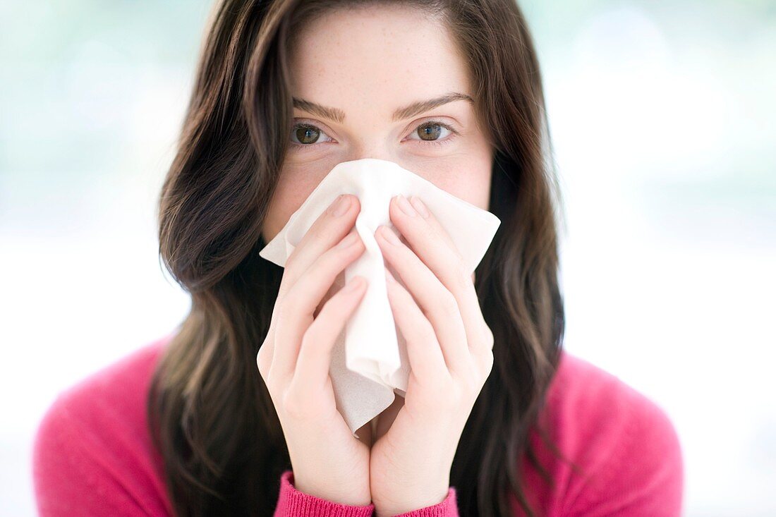 Woman blowing her nose