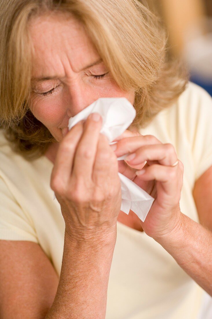 Woman blowing her nose