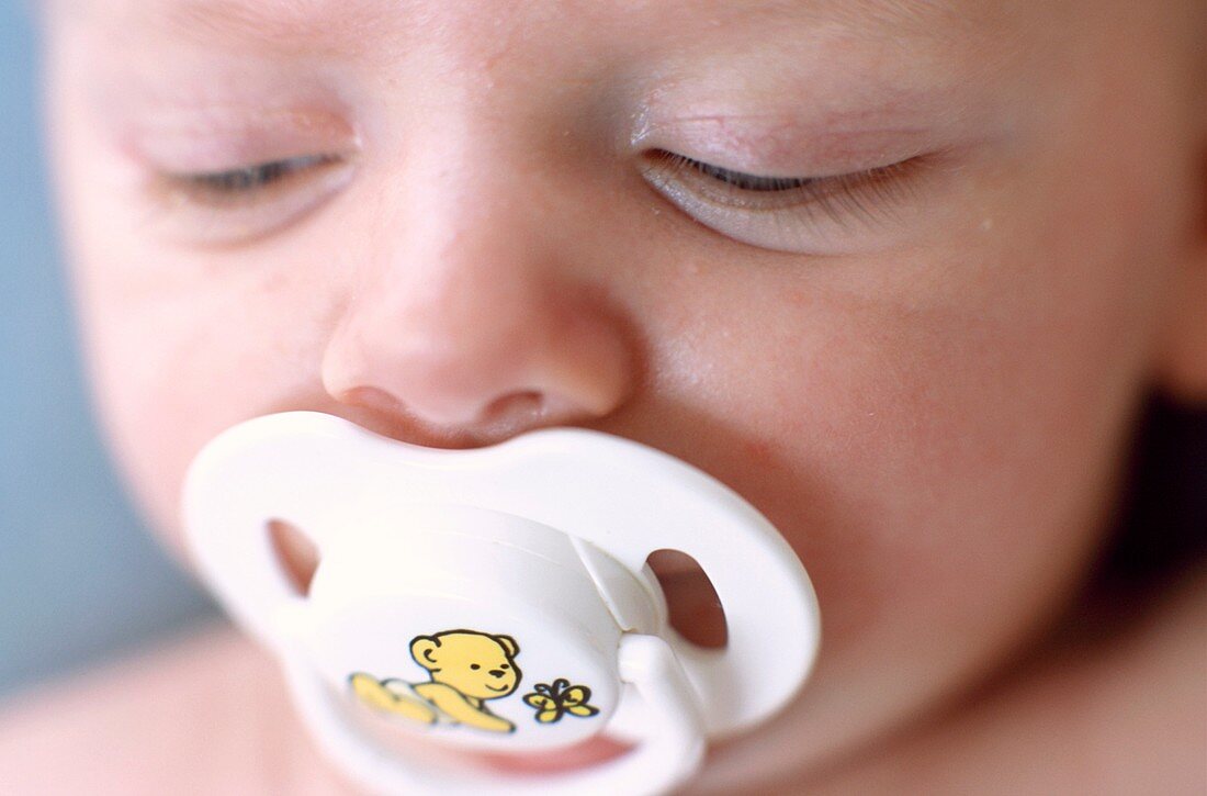 Baby boy sucking a dummy