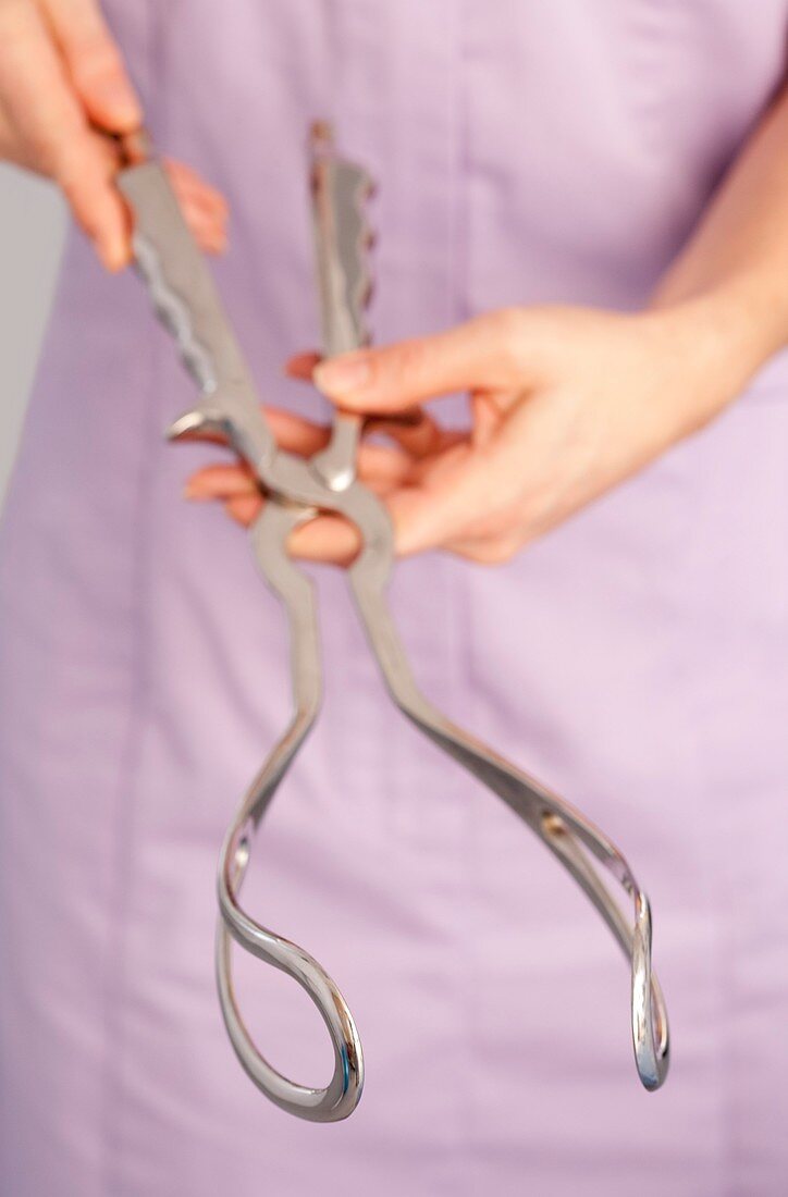 Midwife with obstetric forceps