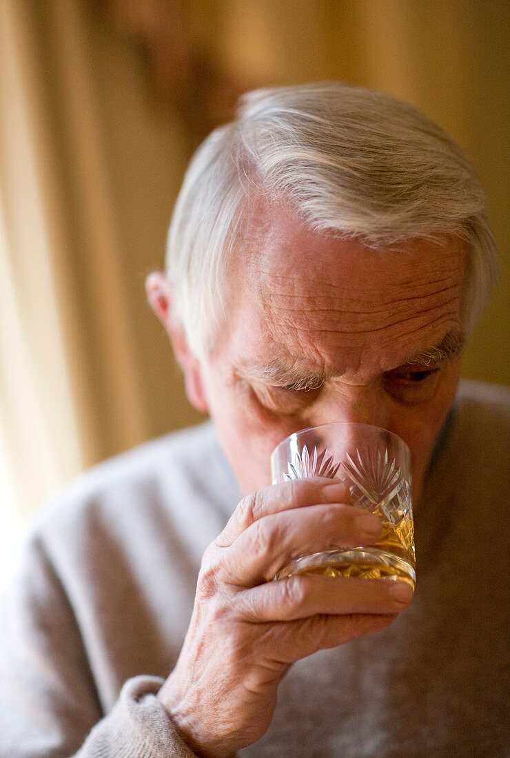 Senior man drinking whiskey