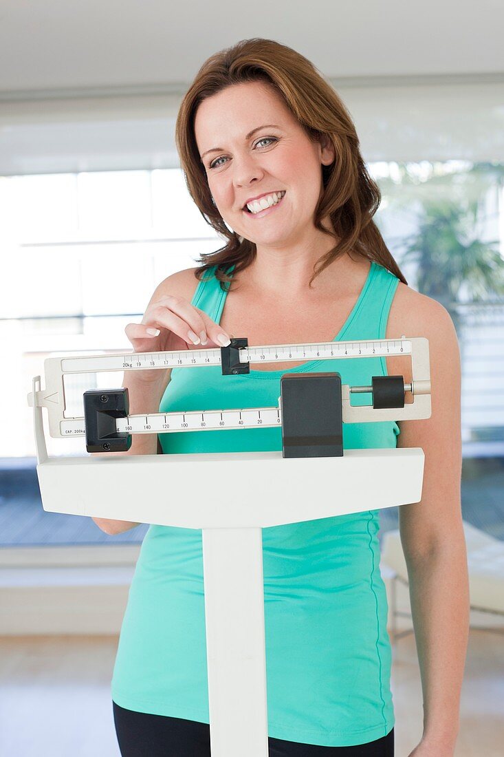 Woman weighing herself