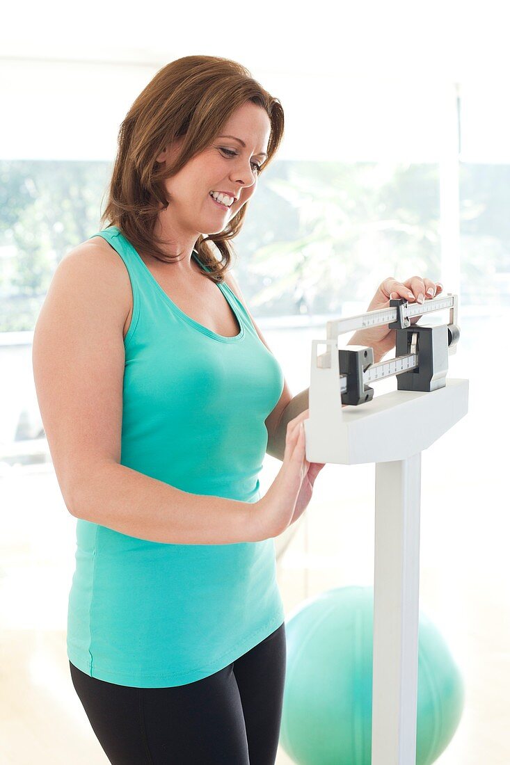 Woman weighing herself