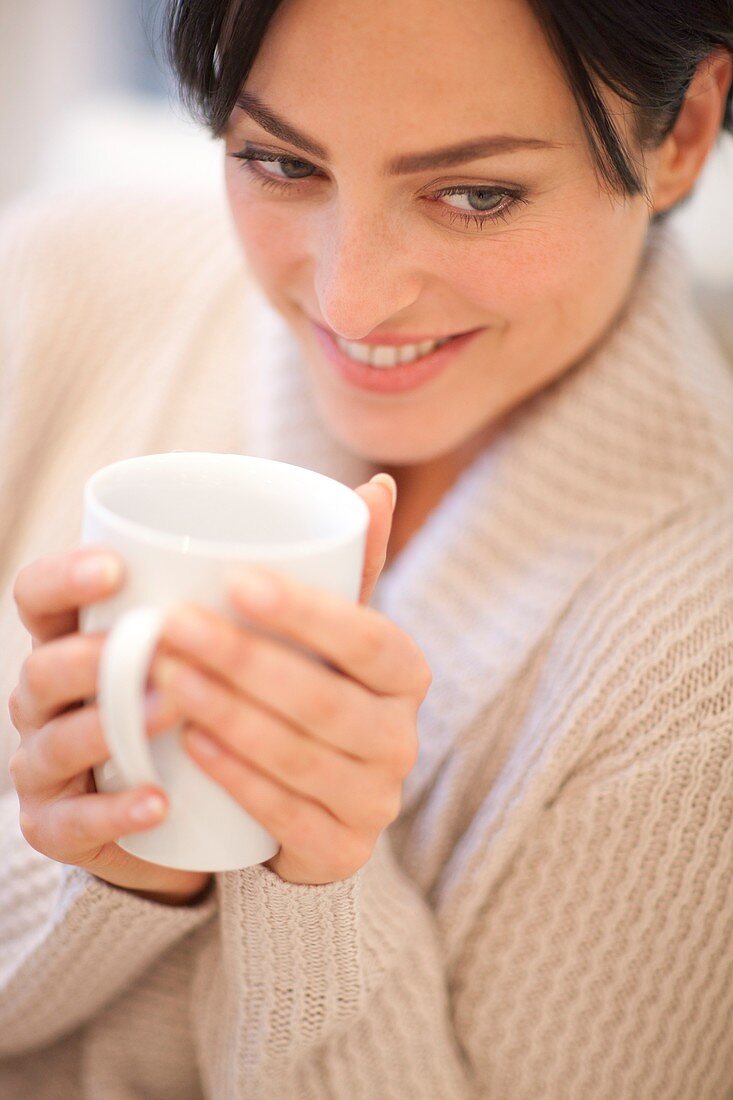 Woman drinking a hot drink