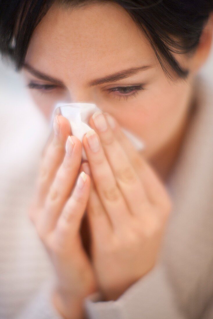 Woman blowing her nose