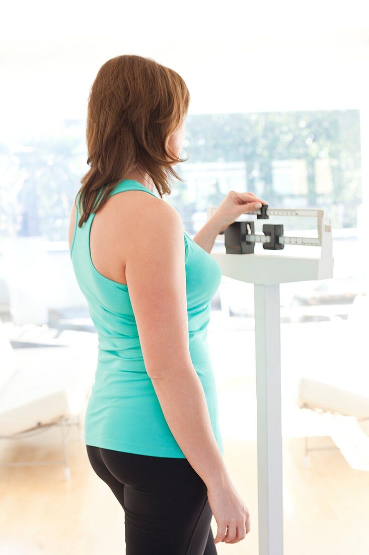 Woman weighing herself