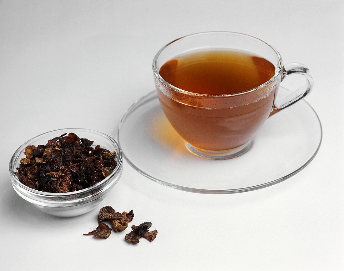 Rose hip tea in cup and rose hip skins in glass bowl