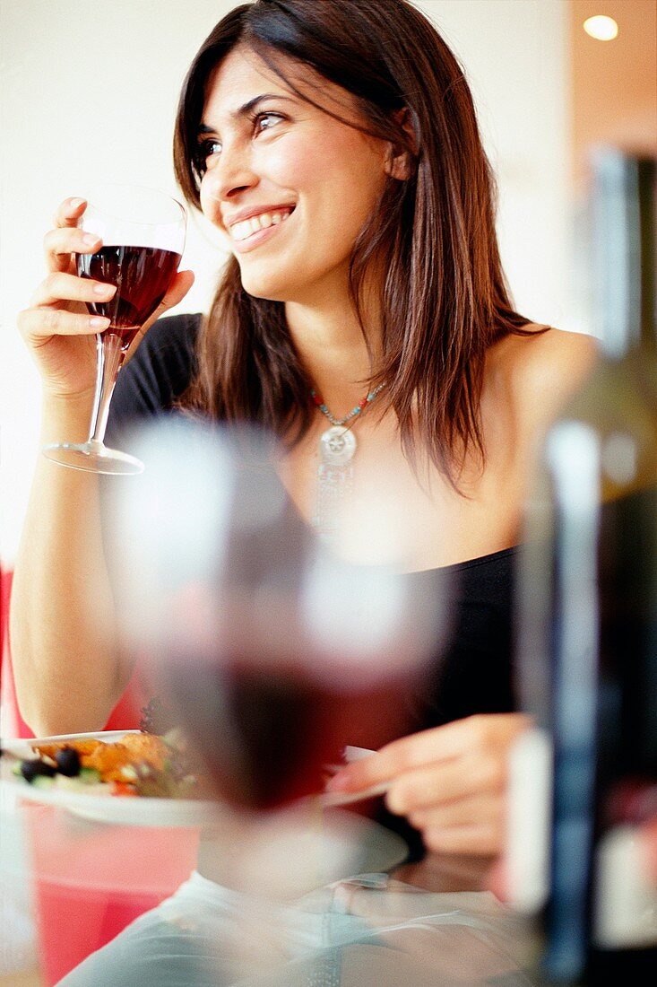 Woman drinking wine with dinner