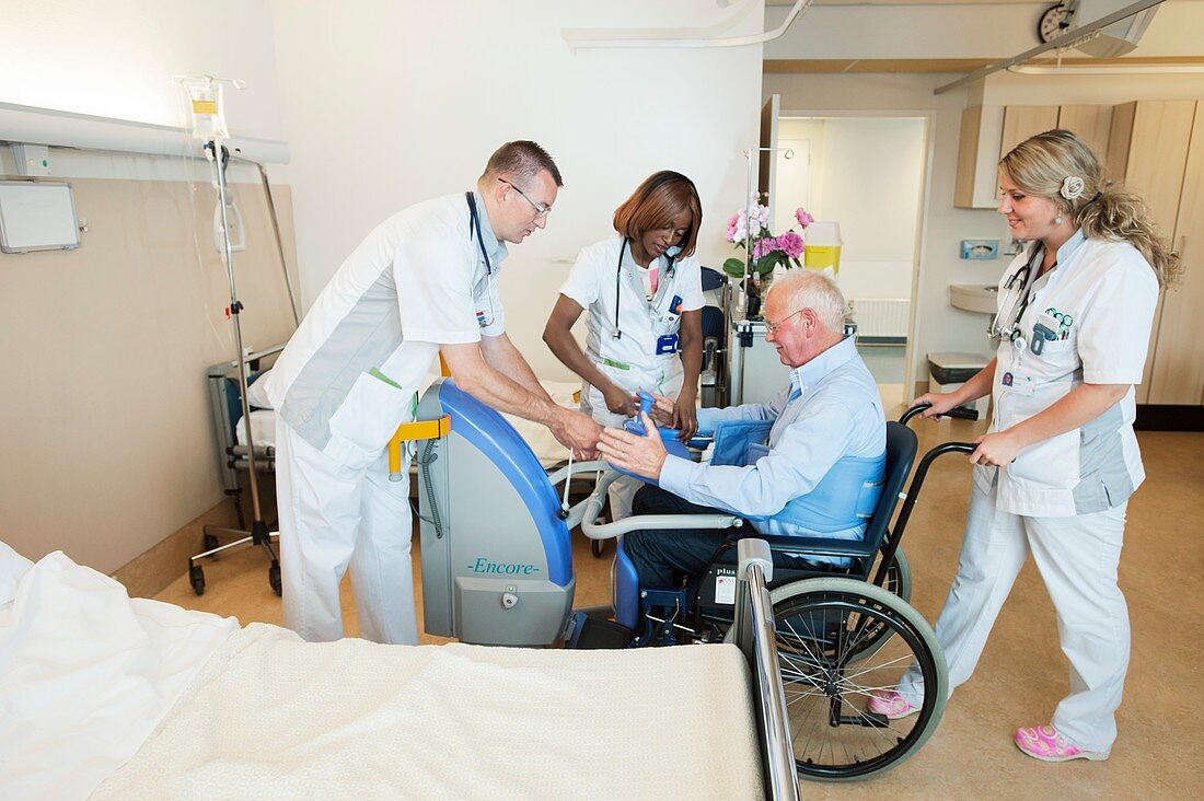Nurses helping a patient out of bed
