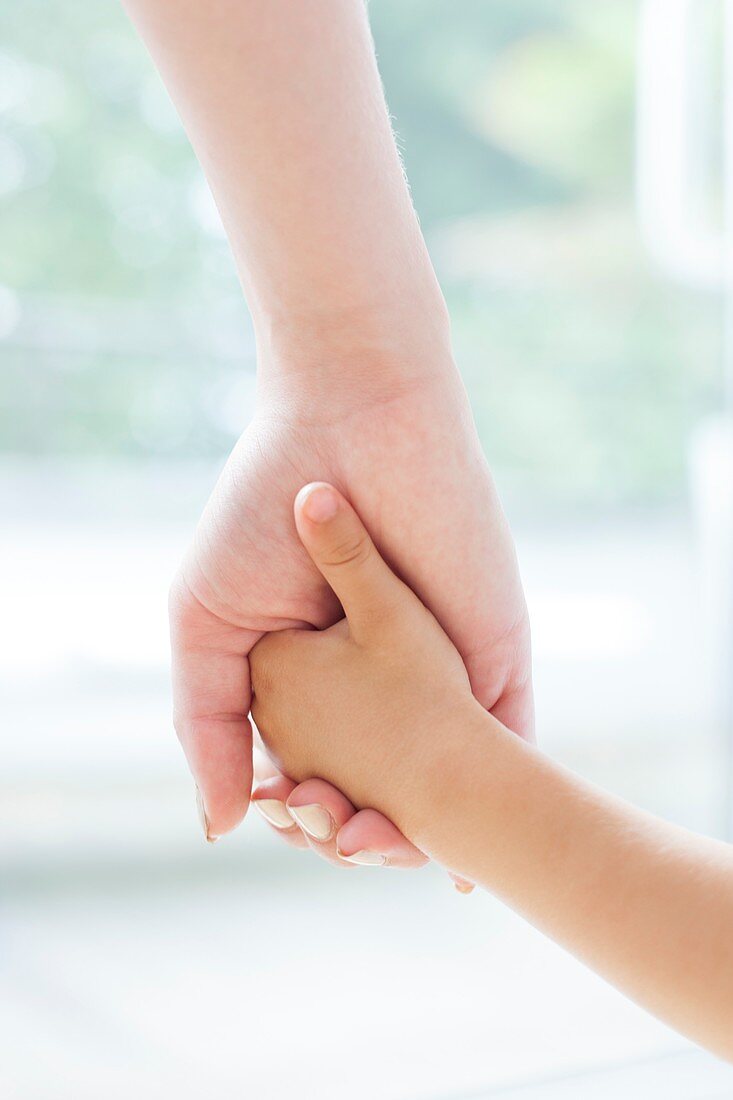 Mother and son holding hands