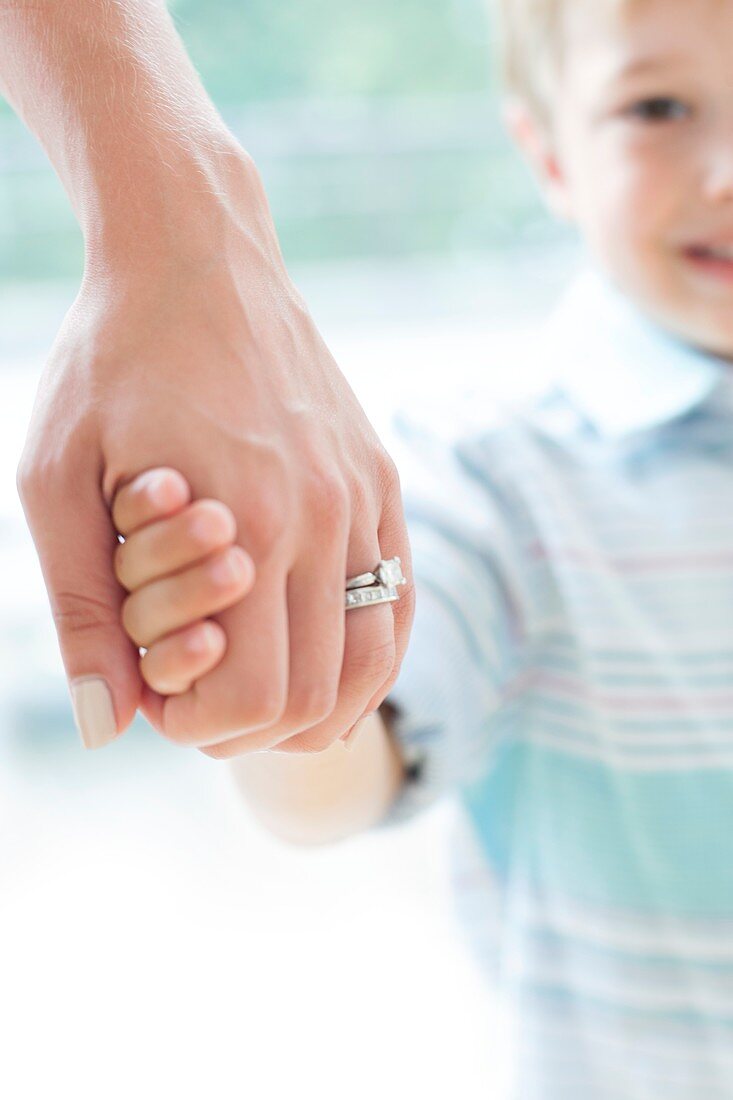 Mother and son holding hands