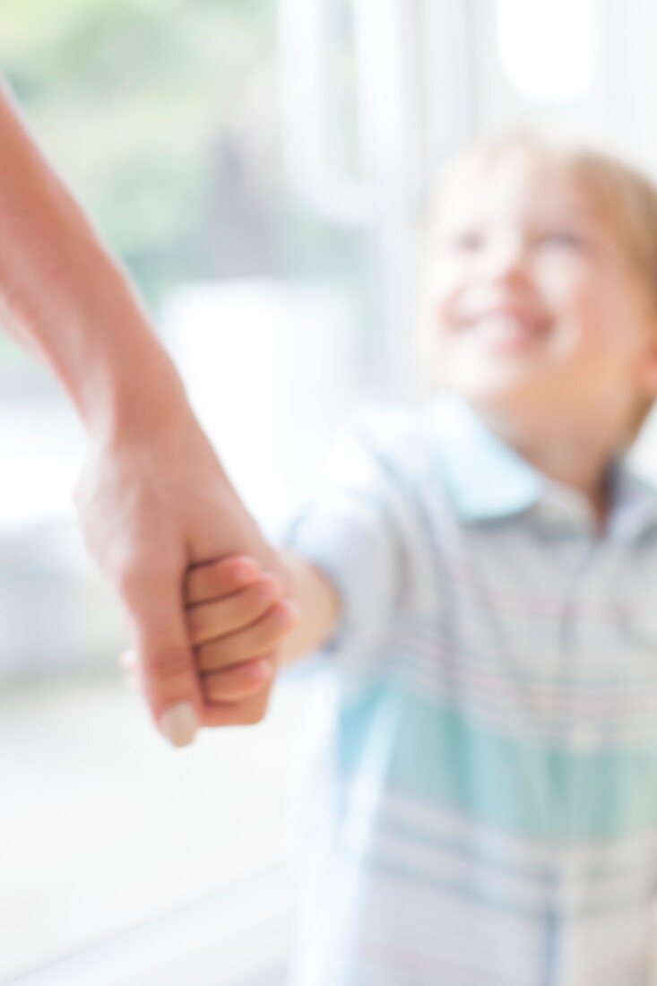 Mother and son holding hands