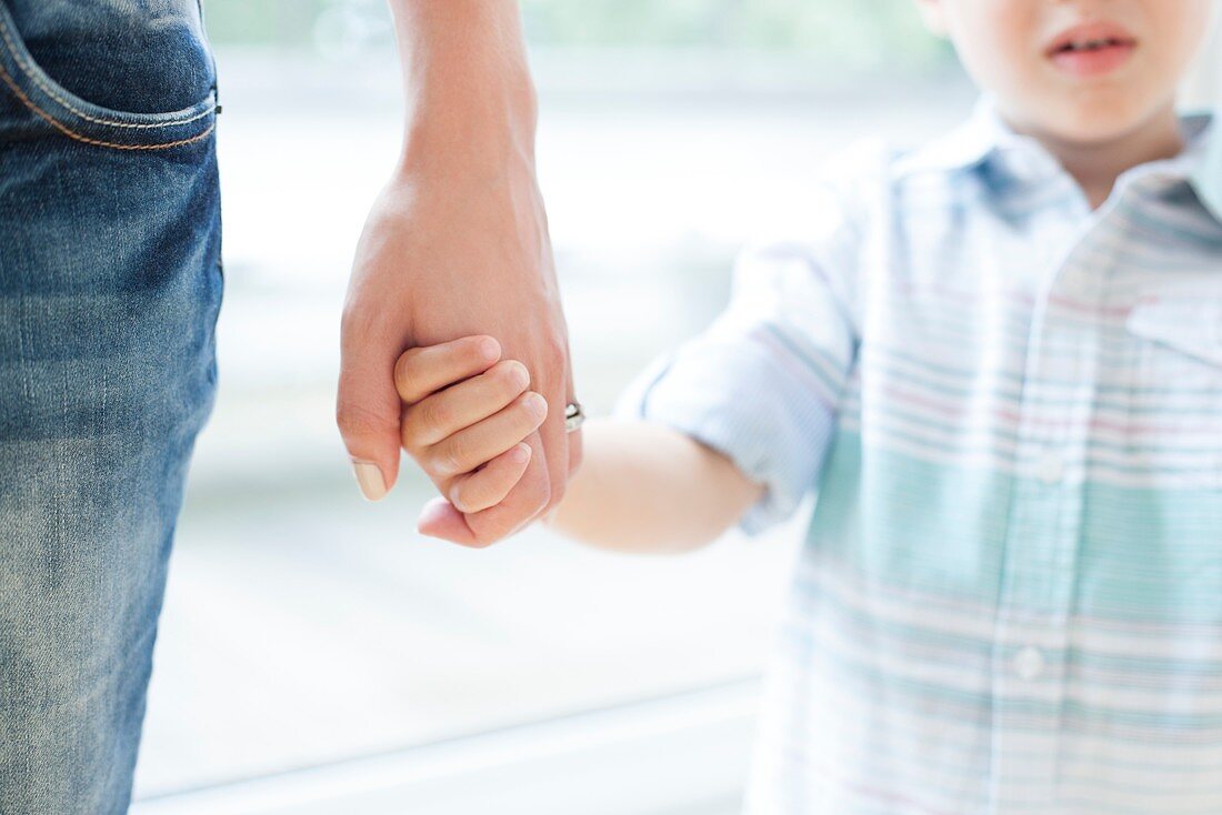 Mother and son holding hands