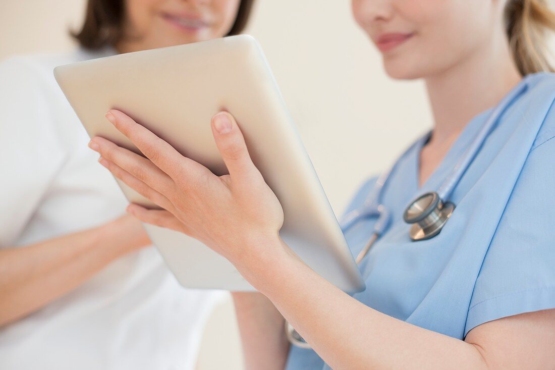 Doctors using a tablet computer