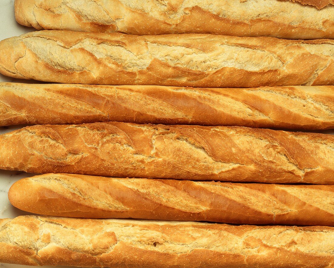 Various fresh baguettes side by side