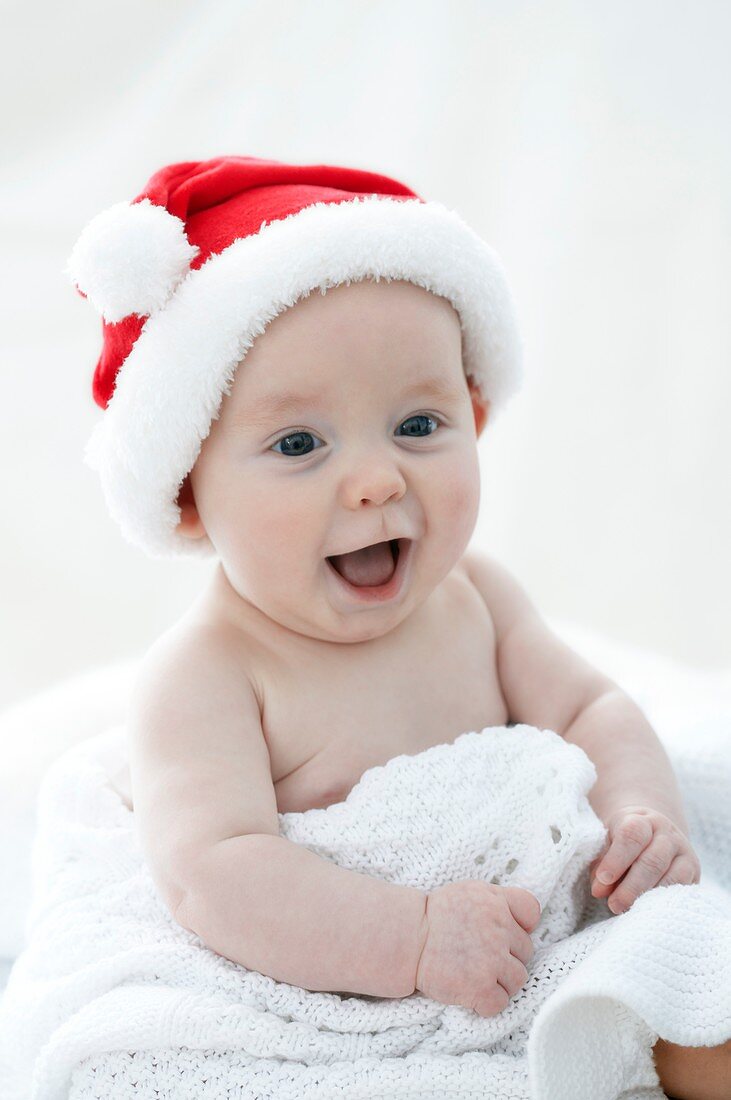 Baby boy wearing Santa hat