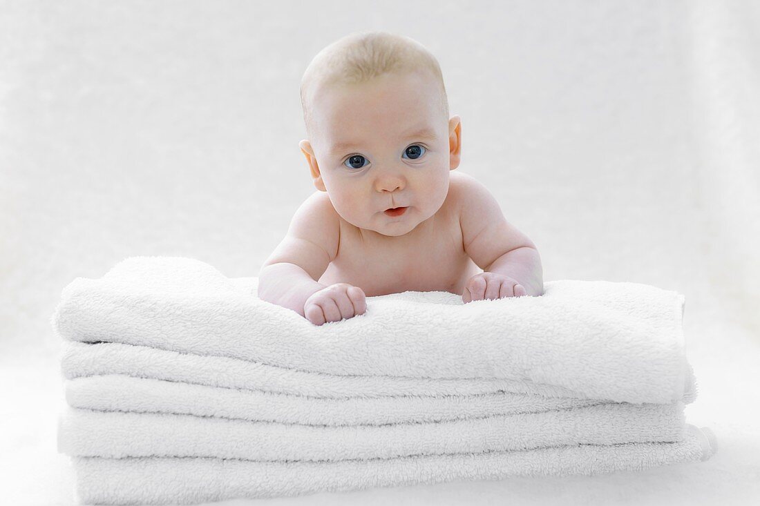 Baby boy lying on towels