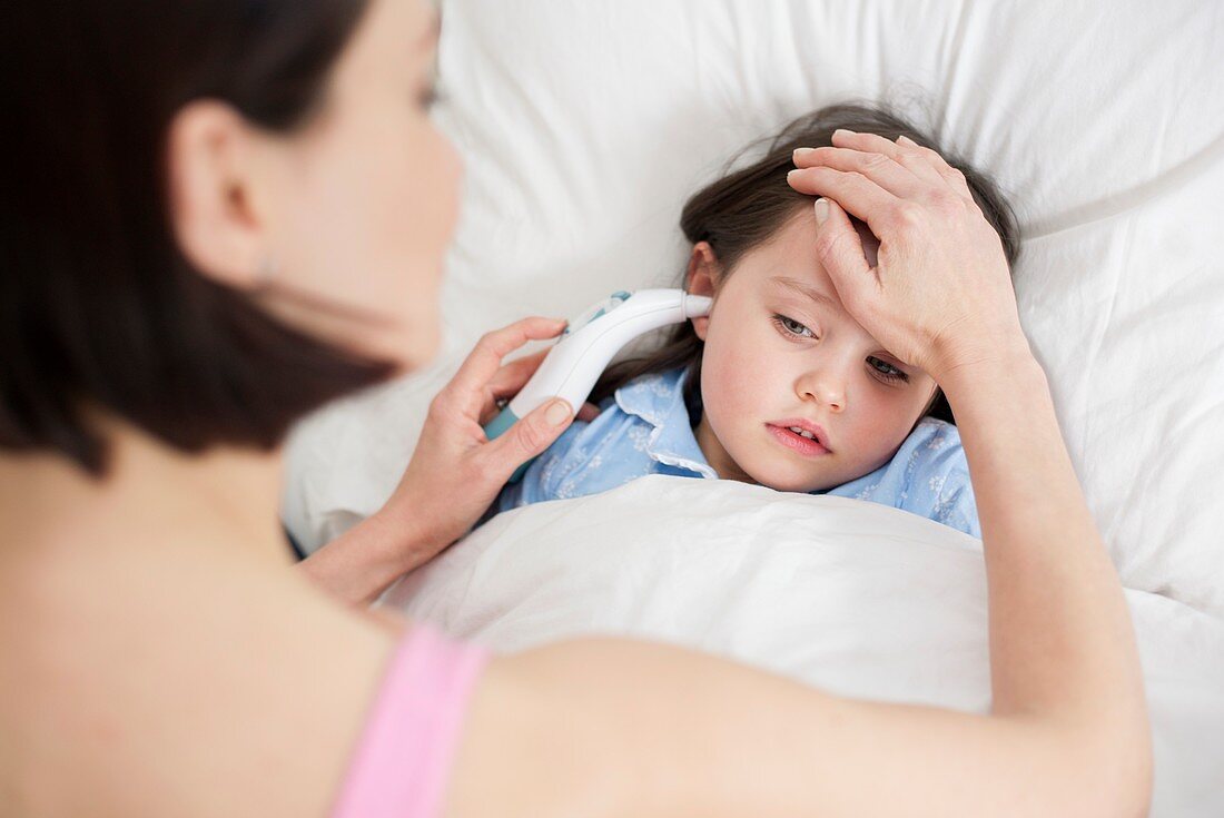 Mother taking daughter's temperature