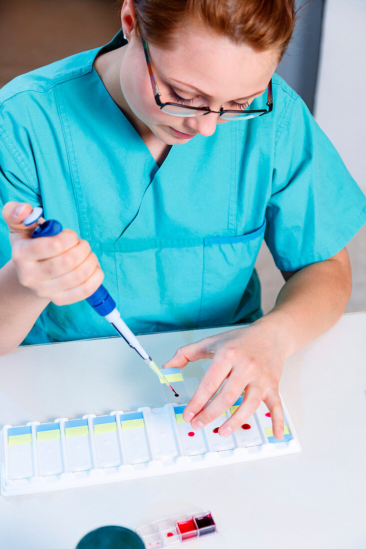 Lab technician using a pipette