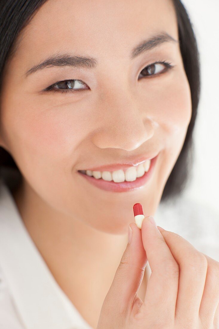 Woman taking tablet