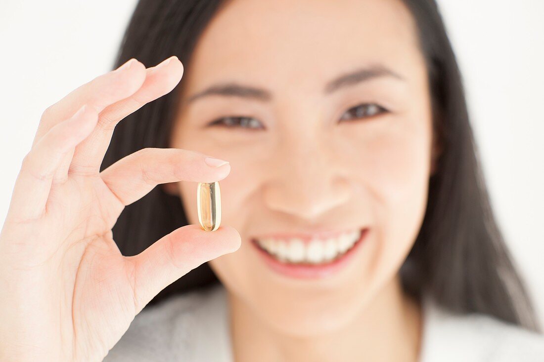 Woman holding capsule