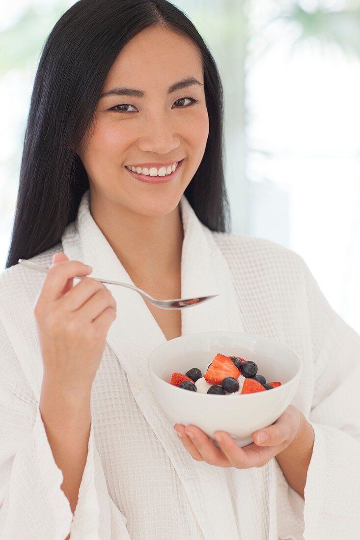 Woman holding bowl of fruit