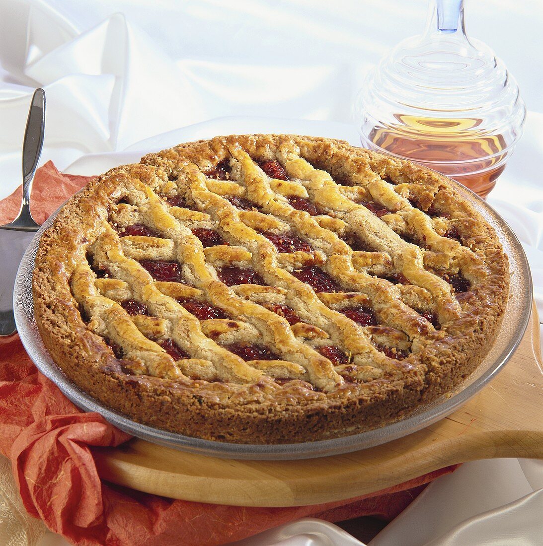 A Linzer tart on cake plate