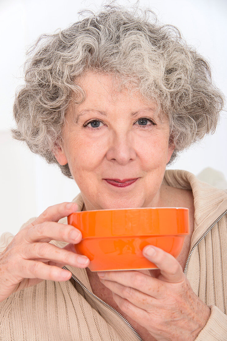 Woman holding an orange bowl
