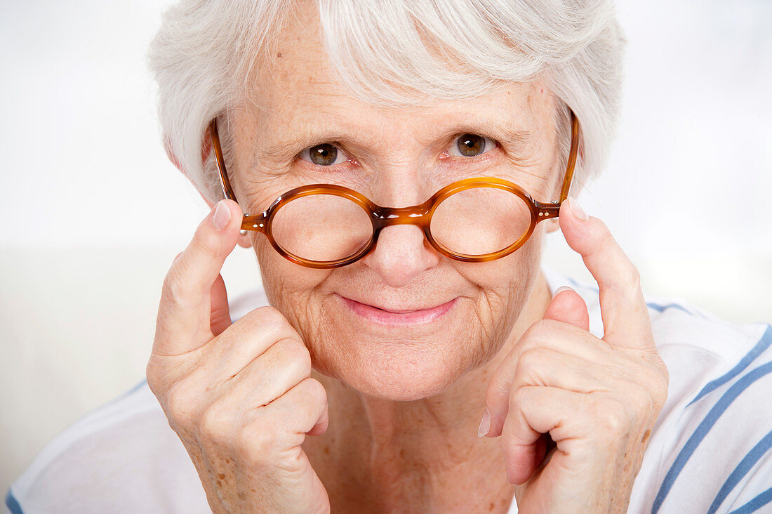 Woman touching glasses
