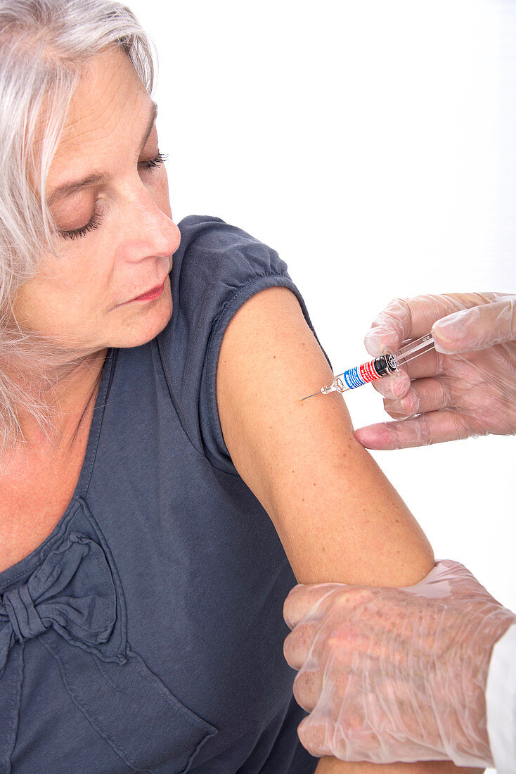 Mature woman receiving vaccination