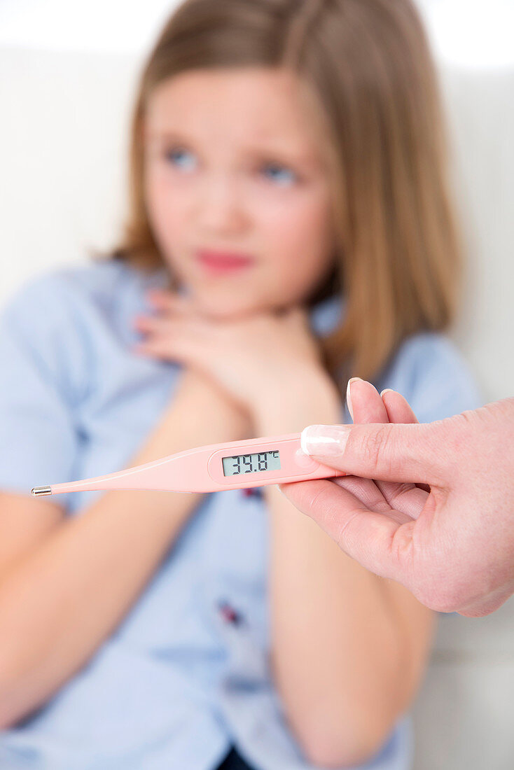 Person holding a digital thermometer