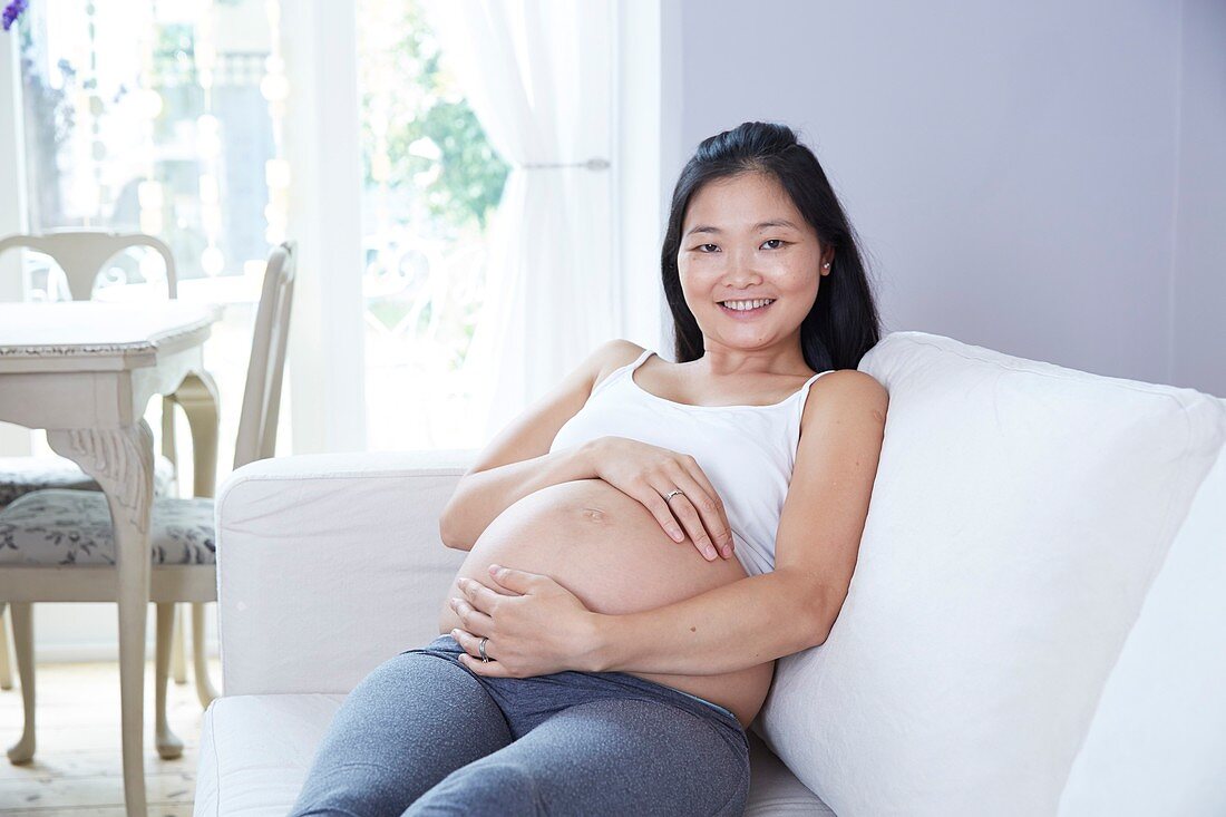 Pregnant woman sitting on sofa