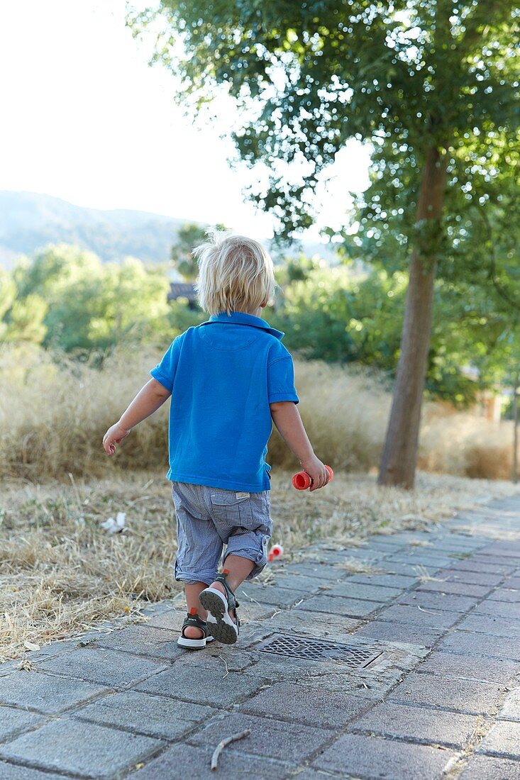 Boy walking on path