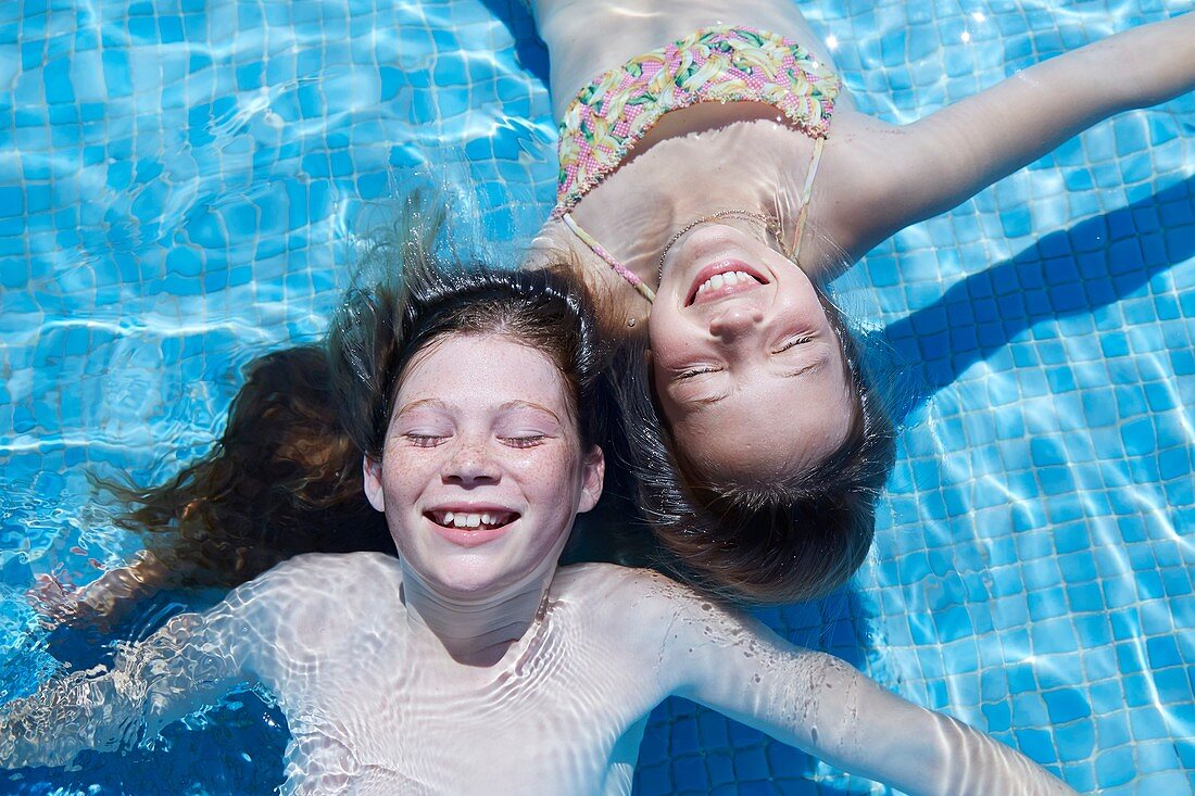 Two girls floating in water