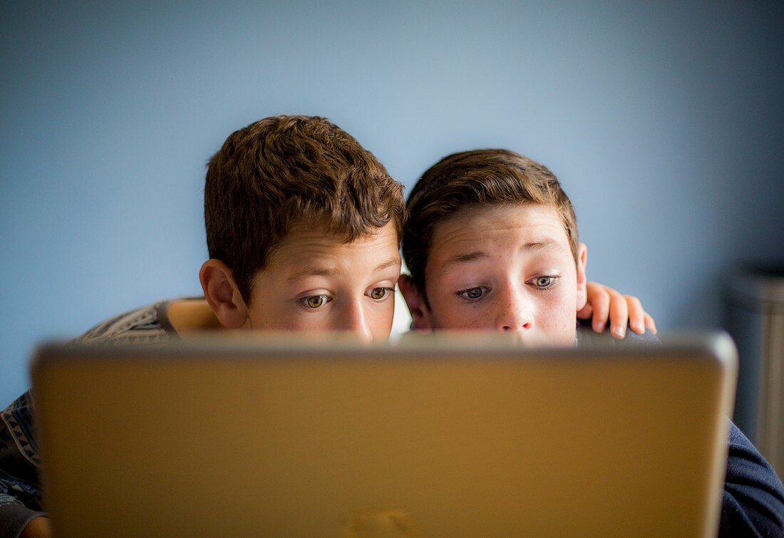 Boys using laptop